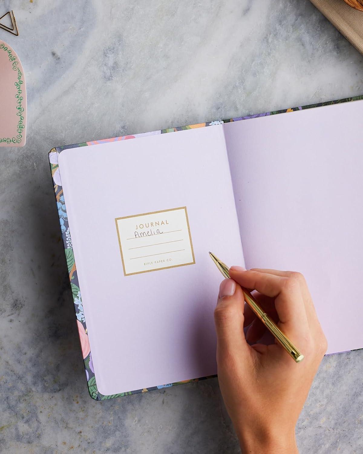 imageRIFLE PAPER CO Journal with Pen Hardcover Journal with Foil Accents 144 Pages Elastic Band Closure Pocket for Extra Storage Patterned in Floral RosaViolet Garden Party